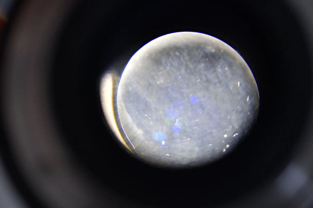 Haze caused by grease that has spread onto the lens elements.