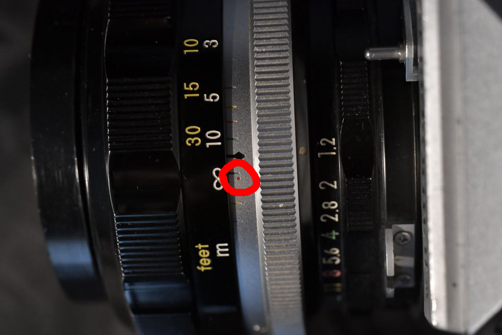 Infrared focusing point indication on a Nikon lens.